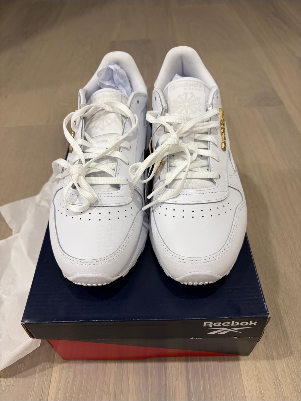 Reebok White Leather Athletic Sneakers with Gold Accent
